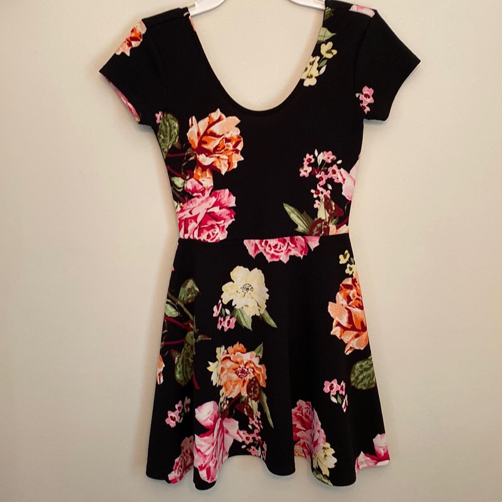 Xs black background with colorful flower pattern